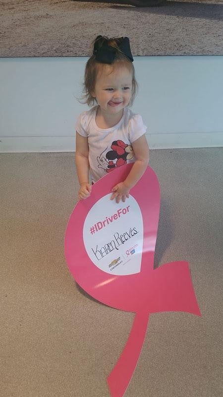 Little girl holding an #IDriveFor Heart