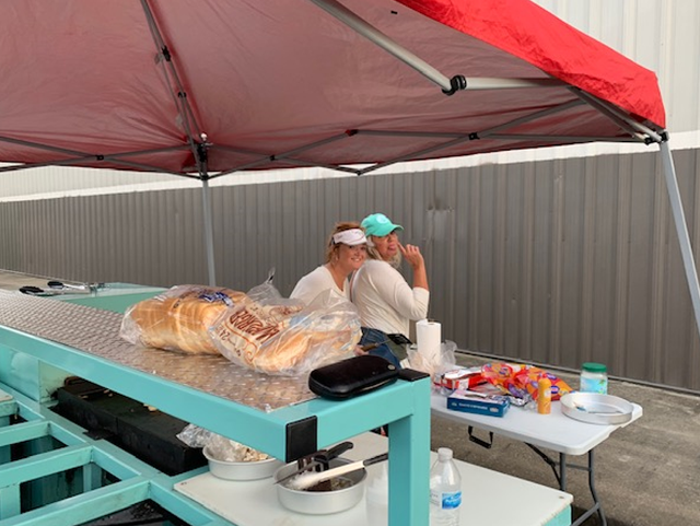 Two women sitting at a table with food